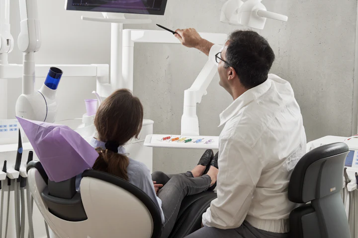 Dentist examining a patient in the treatment chair